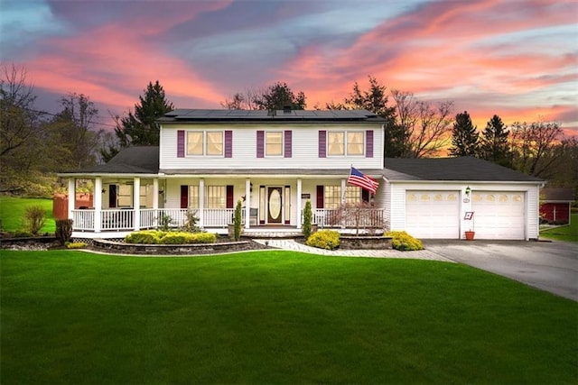 1 Cindy Ln, Highland Mills, NY 10930 - view of front of home featuring covered porch, a garage, asphalt driveway, a front lawn, and roof mounted solar panels