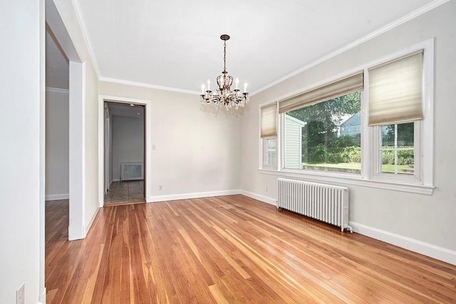 19 Cloverdale Ave, White Plains, NY 10603 - empty room with radiator heating unit, light wood-style flooring, ornamental molding, and a chandelier