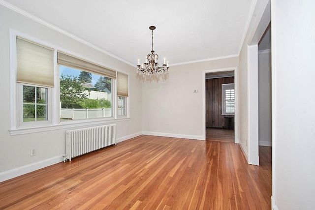 19 Cloverdale Ave, White Plains, NY 10603 - unfurnished room with radiator heating unit, a chandelier, plenty of natural light, light wood-style floors, and crown molding