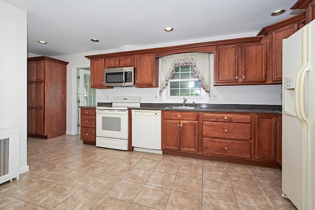 19 Cloverdale Ave, White Plains, NY 10603 - kitchen featuring white appliances, dark countertops, recessed lighting, light tile patterned floors, and brown cabinetry