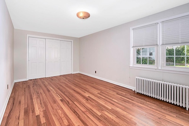 19 Cloverdale Ave, White Plains, NY 10603 - unfurnished bedroom with radiator, wood finished floors, and a closet