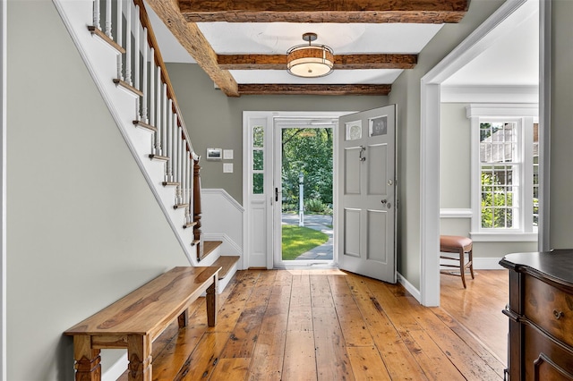 353 Split Rock Rd, Syosset, NY 11791 - foyer with light wood finished floors, plenty of natural light, stairs, and beam ceiling