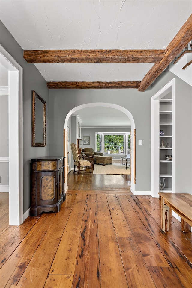353 Split Rock Rd, Syosset, NY 11791 - hall with arched walkways, wood-type flooring, and beamed ceiling