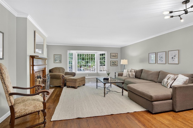 353 Split Rock Rd, Syosset, NY 11791 - living area featuring ornamental molding, wood finished floors, a brick fireplace, and a chandelier