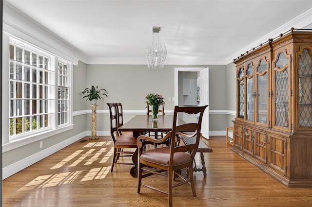 353 Split Rock Rd, Syosset, NY 11791 - dining space with a chandelier, ornamental molding, and wood finished floors
