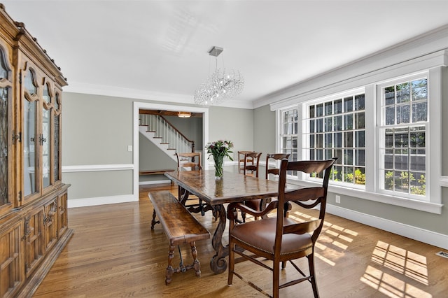 353 Split Rock Rd, Syosset, NY 11791 - dining area featuring stairway, ornamental molding, wood finished floors, and a chandelier