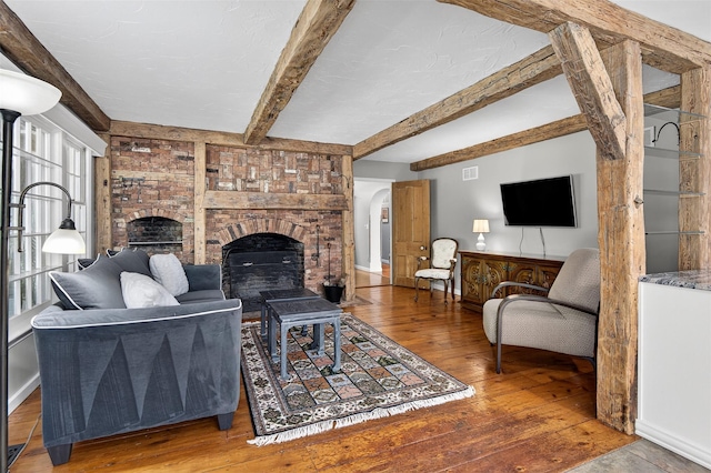 353 Split Rock Rd, Syosset, NY 11791 - living area with hardwood / wood-style flooring, beamed ceiling, and a fireplace