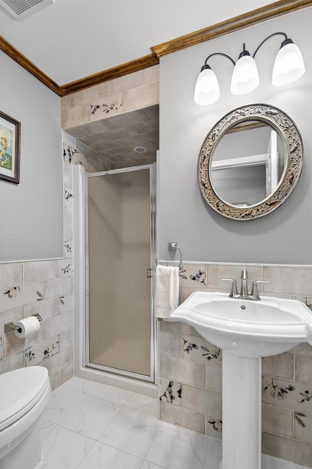 353 Split Rock Rd, Syosset, NY 11791 - bathroom featuring tile walls, crown molding, a shower stall, wainscoting, and marble look tiles