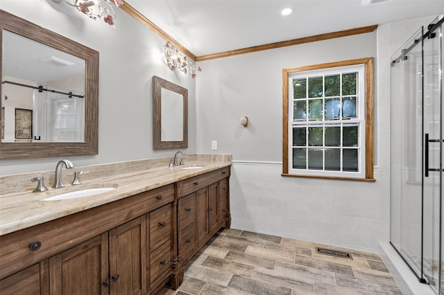 353 Split Rock Rd, Syosset, NY 11791 - full bathroom featuring double vanity, crown molding, a stall shower, wainscoting, and tile walls