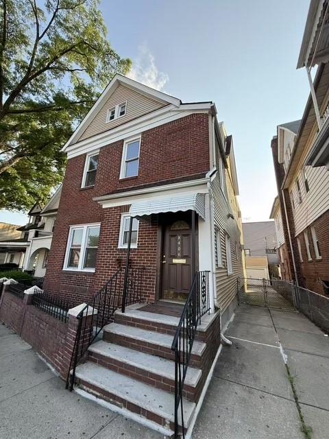 84-06 Woodhaven Blvd, Woodhaven, NY 11421 - view of front of house with brick siding and a gate