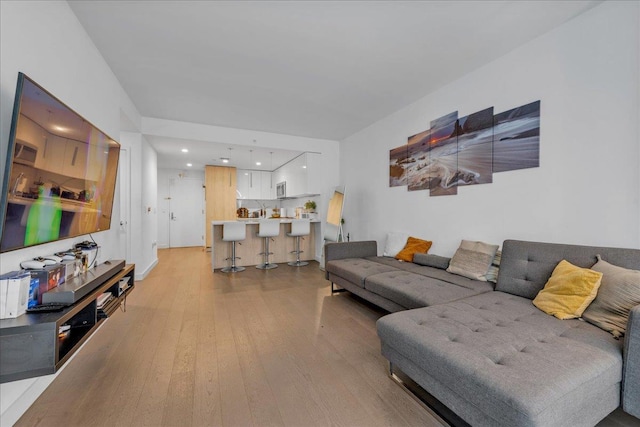 131-05 40th Rd Unit 15G, Flushing, NY 11354 - living area featuring light wood-style floors, recessed lighting, and bar area