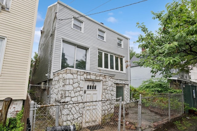 106 Montgomery Ave, Staten Island, NY 10301 - rear view of house with stone siding and a gate