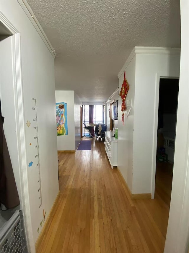 138-35 Elder Ave Unit 4B, Flushing, NY 11355 - hallway with a textured ceiling, light wood-style floors, and crown molding