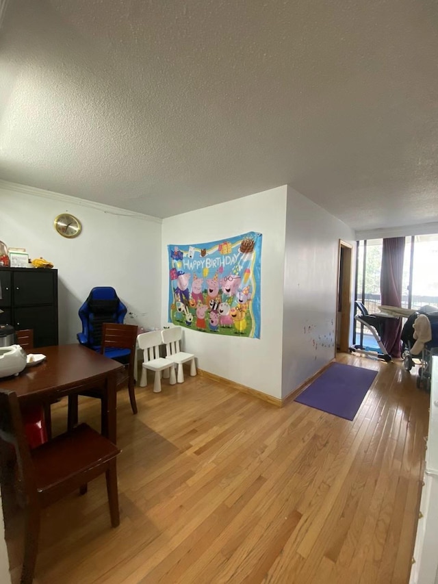 138-35 Elder Ave Unit 4B, Flushing, NY 11355 - dining room with light wood-style floors and a textured ceiling