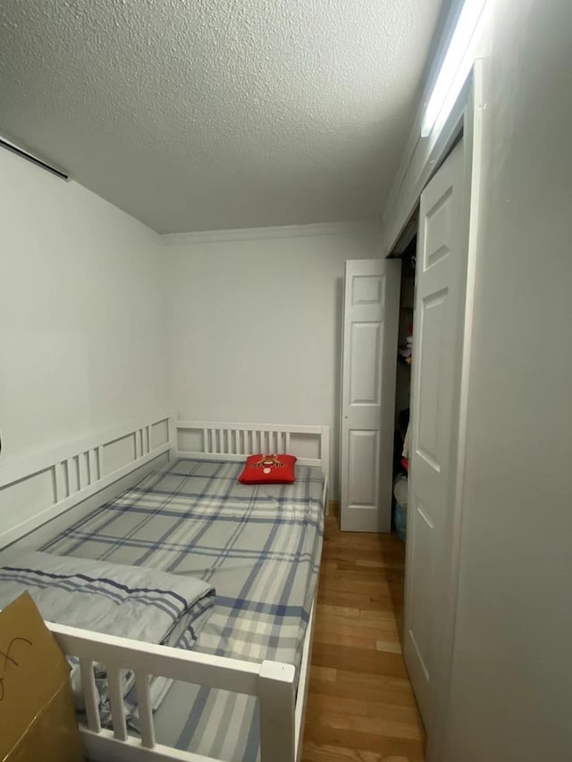 138-35 Elder Ave Unit 4B, Flushing, NY 11355 - bedroom with wood finished floors and a textured ceiling