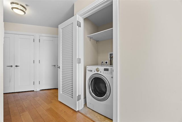 64-05 Yellowstone Blvd Unit 316S, Forest Hills, NY 11375 - washroom with washer / dryer and light wood finished floors