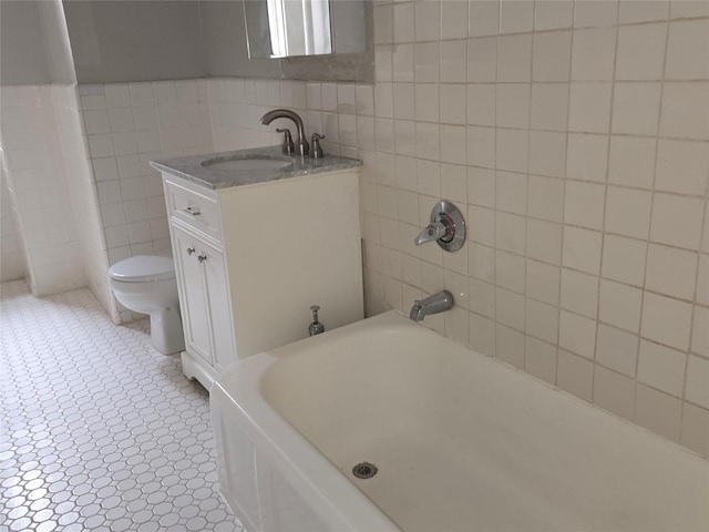 55 E 190th St Unit 45, Bronx, NY 10468 - full bathroom featuring tile walls, vanity, and a tub to relax in
