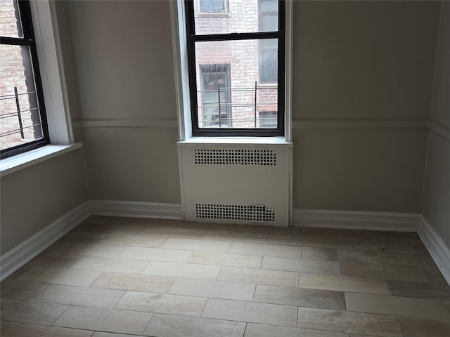 55 E 190th St Unit 45, Bronx, NY 10468 - empty room with radiator heating unit and baseboards