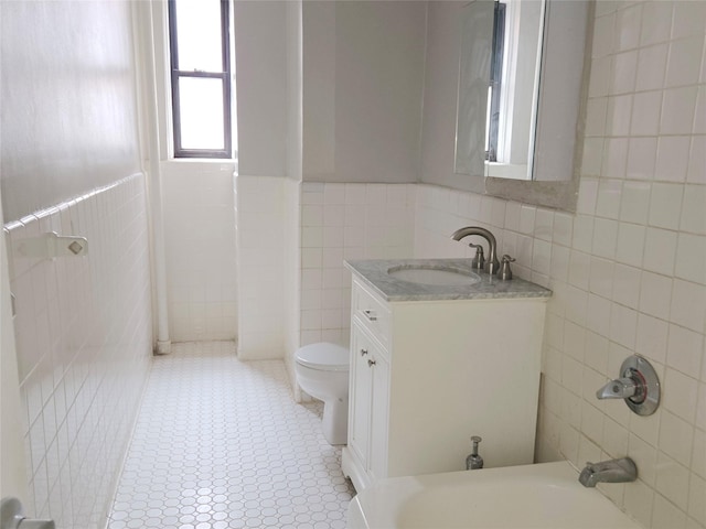 55 E 190th St Unit 45, Bronx, NY 10468 - full bath featuring tile walls, vanity, a bathtub, and wainscoting