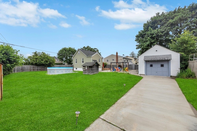 331 44th St, Lindenhurst, NY 11757 - view of yard featuring an outbuilding, a garage, and driveway
