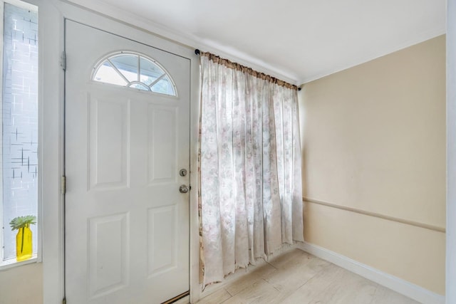 331 44th St, Lindenhurst, NY 11757 - entrance foyer with ornamental molding and light wood-style floors