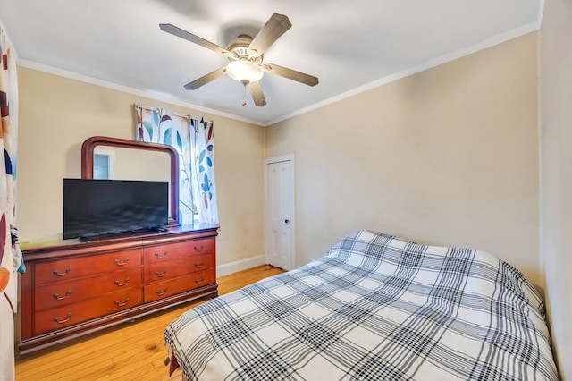 331 44th St, Lindenhurst, NY 11757 - bedroom with light wood finished floors, ornamental molding, a ceiling fan, and a closet