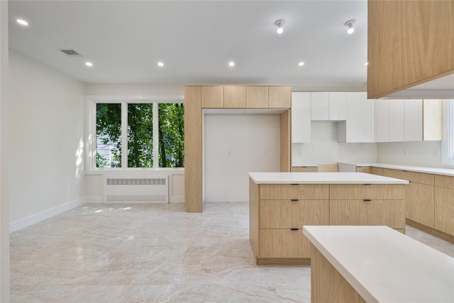 3 Jay St Unit 214, Spring Valley, NY 10977 - kitchen featuring radiator, light brown cabinetry, modern cabinets, recessed lighting, and light marble finish floors