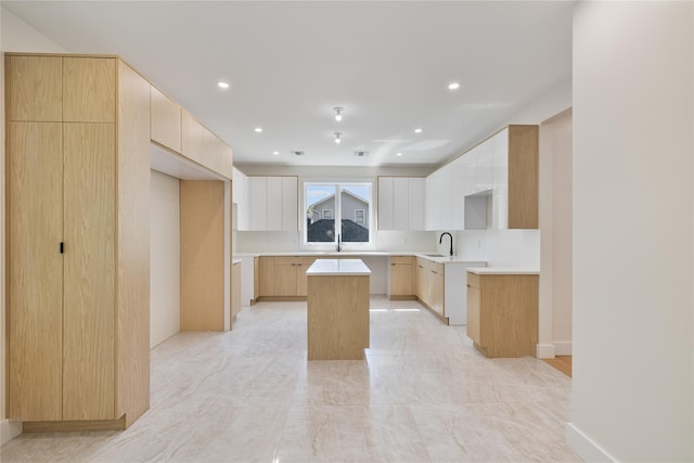 3 Jay St Unit 214, Spring Valley, NY 10977 - kitchen featuring a center island, modern cabinets, light brown cabinets, recessed lighting, and light countertops