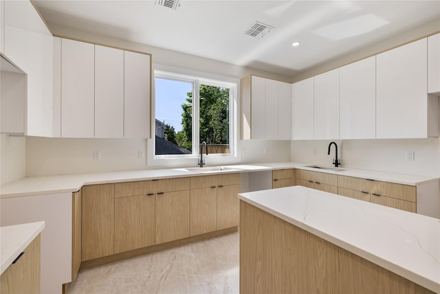 3 Jay St Unit 214, Spring Valley, NY 10977 - kitchen with light stone countertops, modern cabinets, light brown cabinets, and recessed lighting