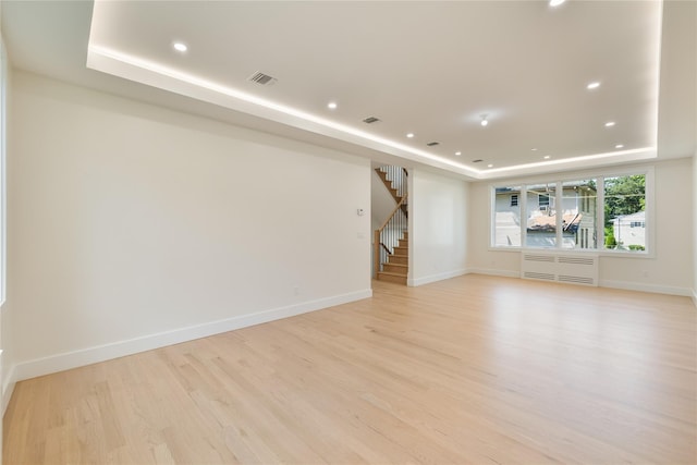 3 Jay St Unit 214, Spring Valley, NY 10977 - spare room with a tray ceiling, stairway, light wood finished floors, and recessed lighting