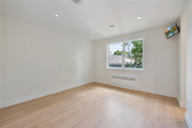 3 Jay St Unit 214, Spring Valley, NY 10977 - spare room with radiator heating unit, light wood-type flooring, recessed lighting, and crown molding