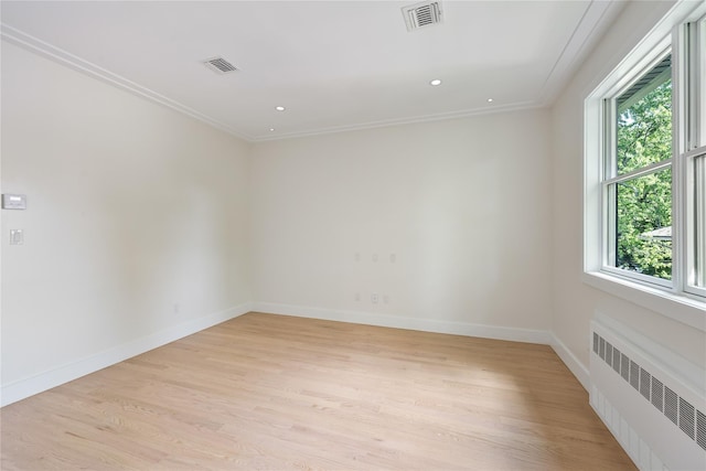 3 Jay St Unit 214, Spring Valley, NY 10977 - spare room featuring radiator, light wood-type flooring, crown molding, and recessed lighting