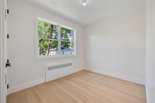 3 Jay St Unit 214, Spring Valley, NY 10977 - empty room with radiator heating unit and wood finished floors