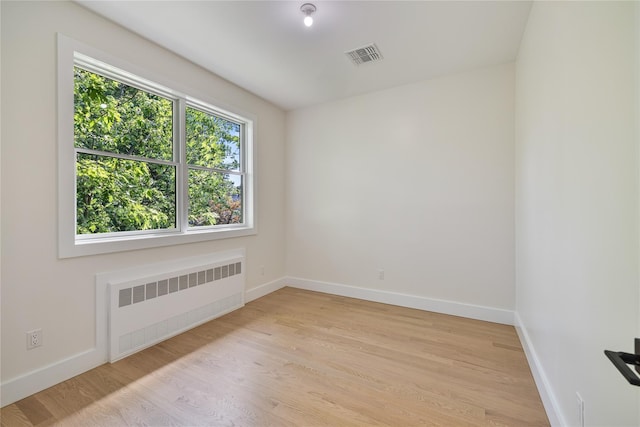 3 Jay St Unit 214, Spring Valley, NY 10977 - spare room featuring radiator heating unit and light wood-type flooring