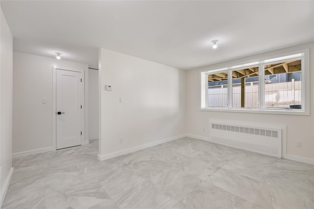 3 Jay St Unit 214, Spring Valley, NY 10977 - unfurnished room featuring radiator heating unit and light marble finish flooring