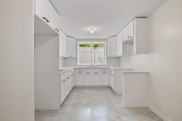 3 Jay St Unit 214, Spring Valley, NY 10977 - kitchen featuring white cabinetry, light marble finish floors, and light countertops
