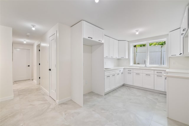 3 Jay St Unit 214, Spring Valley, NY 10977 - kitchen with light marble finish flooring, white cabinetry, and light countertops