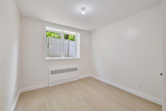 3 Jay St Unit 214, Spring Valley, NY 10977 - empty room with radiator and wood finished floors