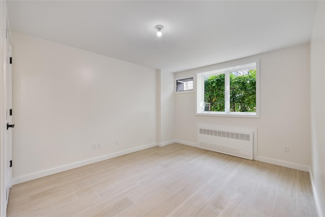 3 Jay St Unit 214, Spring Valley, NY 10977 - spare room with radiator heating unit and light wood-style floors