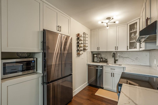 166-41 Powells Cove Blvd Unit 4B, Beechhurst, NY 11357 - kitchen with stainless steel appliances, under cabinet range hood, dark wood-style floors, light stone counters, and glass insert cabinets