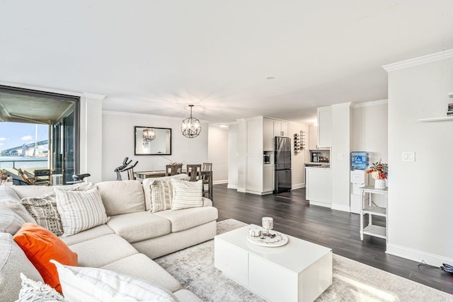 166-41 Powells Cove Blvd Unit 4B, Beechhurst, NY 11357 - living room featuring crown molding, dark wood-type flooring, and a chandelier