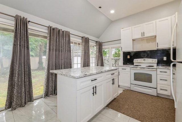 404 Foxdale Ave, Oceanside, NY 11572 - kitchen featuring white appliances, vaulted ceiling, decorative backsplash, white cabinets, and a center island