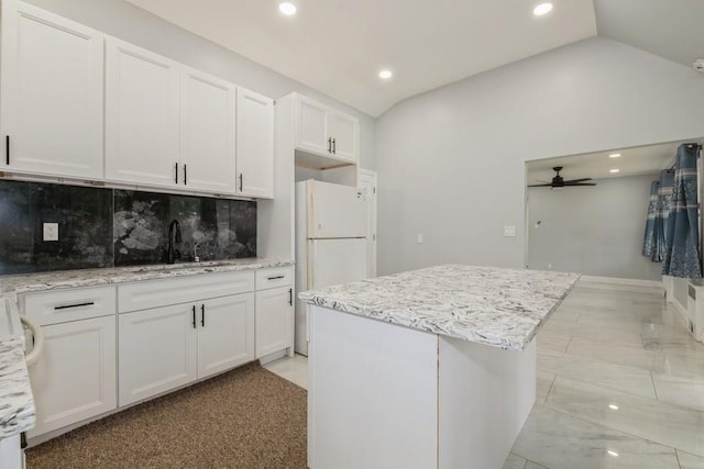 404 Foxdale Ave, Oceanside, NY 11572 - kitchen featuring recessed lighting, ceiling fan, a center island, white cabinetry, and light stone countertops