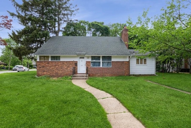 404 Foxdale Ave, Oceanside, NY 11572 - view of front of house featuring a front yard, brick siding, a chimney, and roof with shingles
