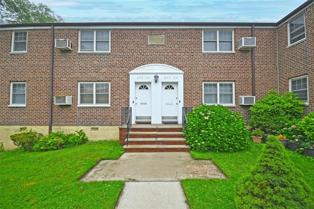 251-26 58th Ave Upper, Upper, Little Neck, NY 11362 - view of property with crawl space, brick siding, a front yard, and an AC wall unit