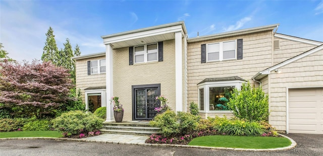 74 Woods Dr, Roslyn, NY 11576 - view of front of house with an attached garage and asphalt driveway