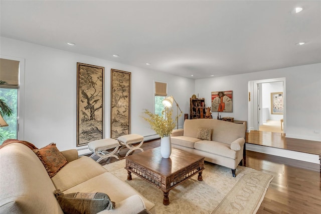 74 Woods Dr, Roslyn, NY 11576 - living area with wood finished floors, recessed lighting, and a baseboard heating unit