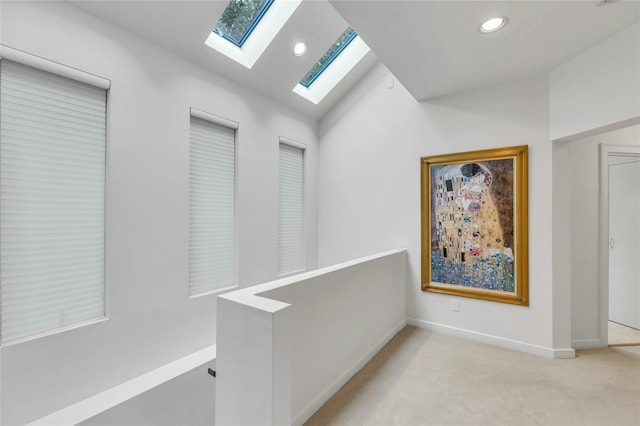74 Woods Dr, Roslyn, NY 11576 - hallway featuring a skylight, light carpet, recessed lighting, an upstairs landing, and vaulted ceiling