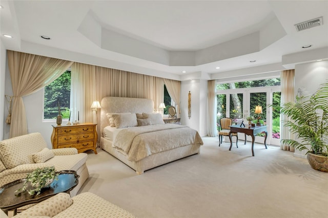 74 Woods Dr, Roslyn, NY 11576 - bedroom featuring light colored carpet, french doors, recessed lighting, and a tray ceiling