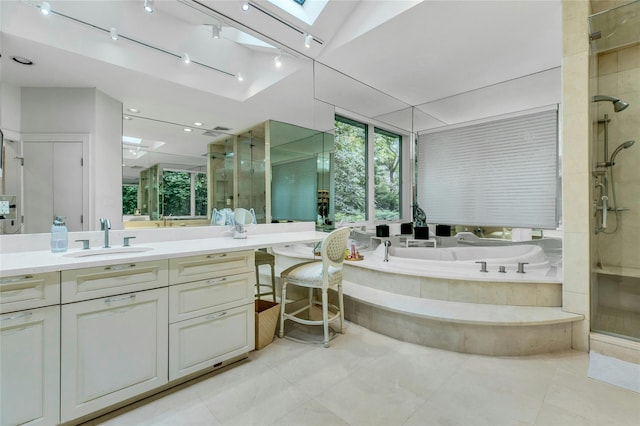 74 Woods Dr, Roslyn, NY 11576 - bathroom with a skylight, a shower stall, a garden tub, vanity, and tile patterned floors